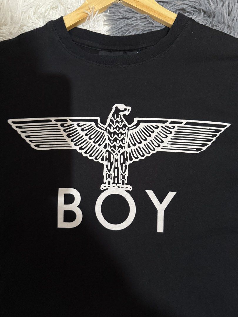 Boy London Eagle Logo Black T-Shirt (Category: Tshirts & Polo Shirts ) located in Manila. Submitted by keepercollection (Listing ID 1470831210, Image 2). Description: Boy London tee in classic black. Big white eagle graphic printed right on the front with bold BOY lettering underneath. Standard crew neck and short sleeves. Tag on the inside neck shows the brand. Clean fabric, measurements pictured with tape. Pit to pit measures around twenty inch