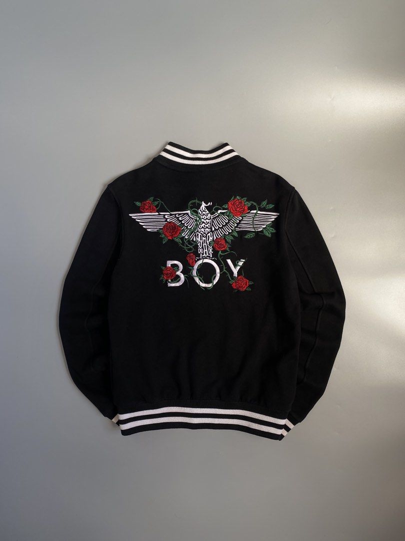 Boy London Rose Embroidery Varsity Jacket (Category: Coats, Jackets and Outerwear) located in Cavite. Submitted by awuuu27 (Listing ID 1470748013, Image 1). Description: B0Y L0ND0N Varsity Jacket 💎 DIMES: Width-20/Length-25(S-M) CONDITION: 9.5/10 COLOR RATE: 9.5/10 ISSUE: noneorn circle - Back Design: Large white eagle graphic, 'BOY' lettering, and embroidered red roses with green vines.