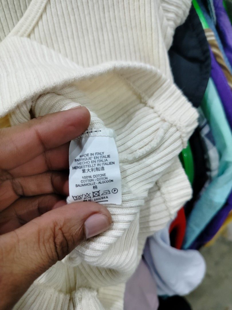 Brandy Melville Ribbed Button-Down Short Sleeve Top White (Category: Shirts) located in Manila. Submitted by virgiliosa38485 (Listing ID 1470786651, Image 3). Description: - Brand: Brandy Melville - Color: Off-white / Cream - Material: 100% Cotton (Made in Italy) - Features: Short sleeves, scoop neckline, full button front - Fit: Soft, ribbed knit fabric with great stretch - Style tip: Perfect basic piece to pair with high-waisted jeans or skirts