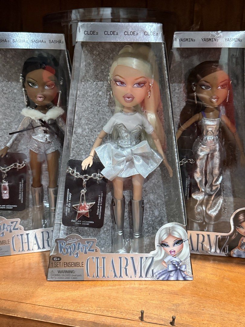 BRATZ CHARMZ SET (Category: Kids Toys) located in Quezon City. Submitted by deporky (Listing ID 1470838518, Image 1). Description: - Complete Bratz Charmz collection including Cloe, Sasha, and Yasmin dolls - Dressed in stylish shiny silver outfits and matching silver boots - Comes brand new in original clear-window packaging - Includes exclusive collectible charm chains for each doll: - Cloe: Blonde hair with star charm - Sasha: Dark hair with ph