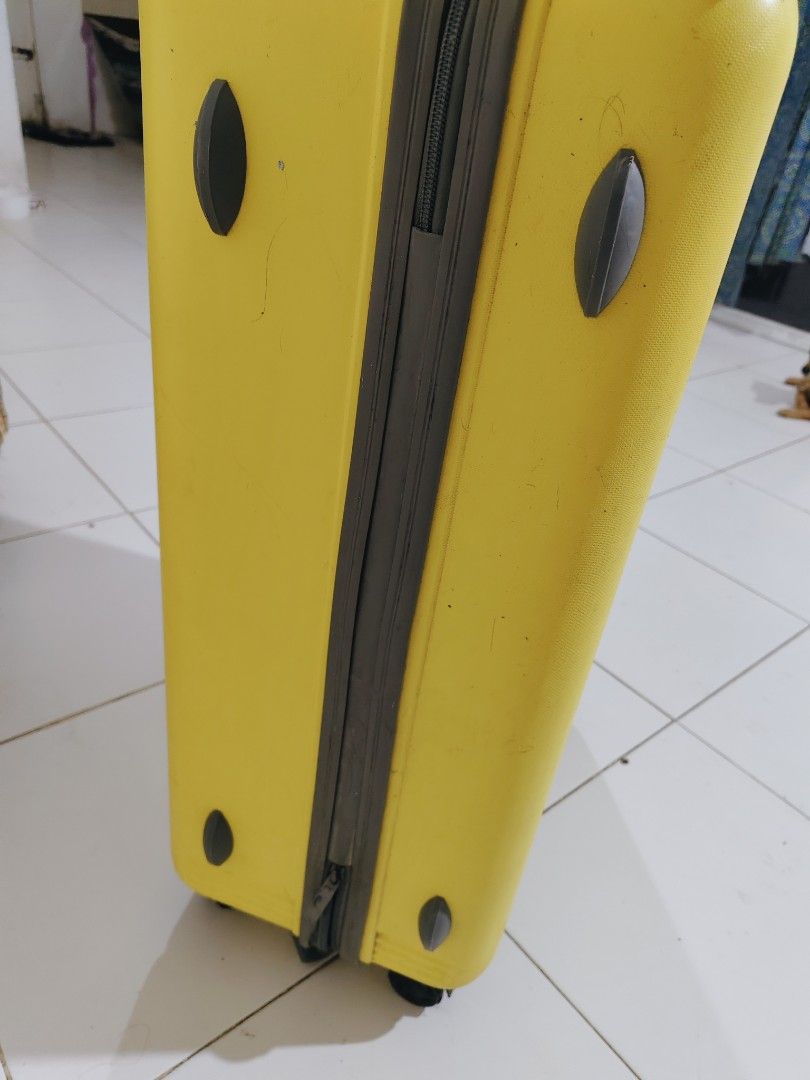 Bright Yellow Rolling Suitcase with Retractable Handle (Category: Luggage) located in Bulacan. Submitted by babz30261 (Listing ID 1470836907, Image 3). Description: Bright yellow hardside suitcase. Smooth rolling wheels on the bottom. Telescoping metal handle pulls up and locks easily. Sturdy zipper closure runs down the middle. Journey Man luggage tag attached near the top. Good size for weekend trips or checked baggage. Shows minor scuffs from 