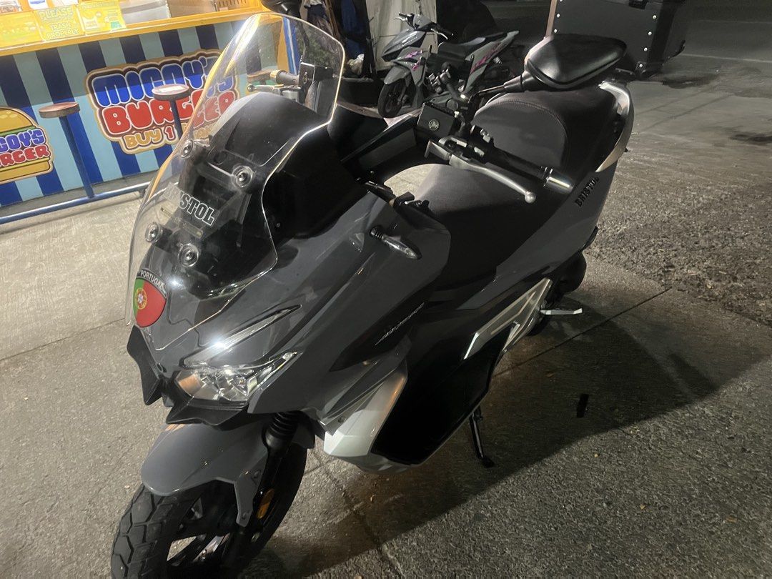 Bristol Maxie 400 Scooter Grey (Category: Motorbikes for Sale) located in Manila. Submitted by xyanity_300 (Listing ID 1470747816, Image 3). Description: 8k+ mileage. Registered this august Complete papers Grey Bristol Maxie 400 maxi scooter. Big windshield up front, comfortable contoured seat. Rear top box included for extra storage. Dual front headlights, chunky tires, clean bodywork overall. Rides smooth, handles daily commutes and longer road