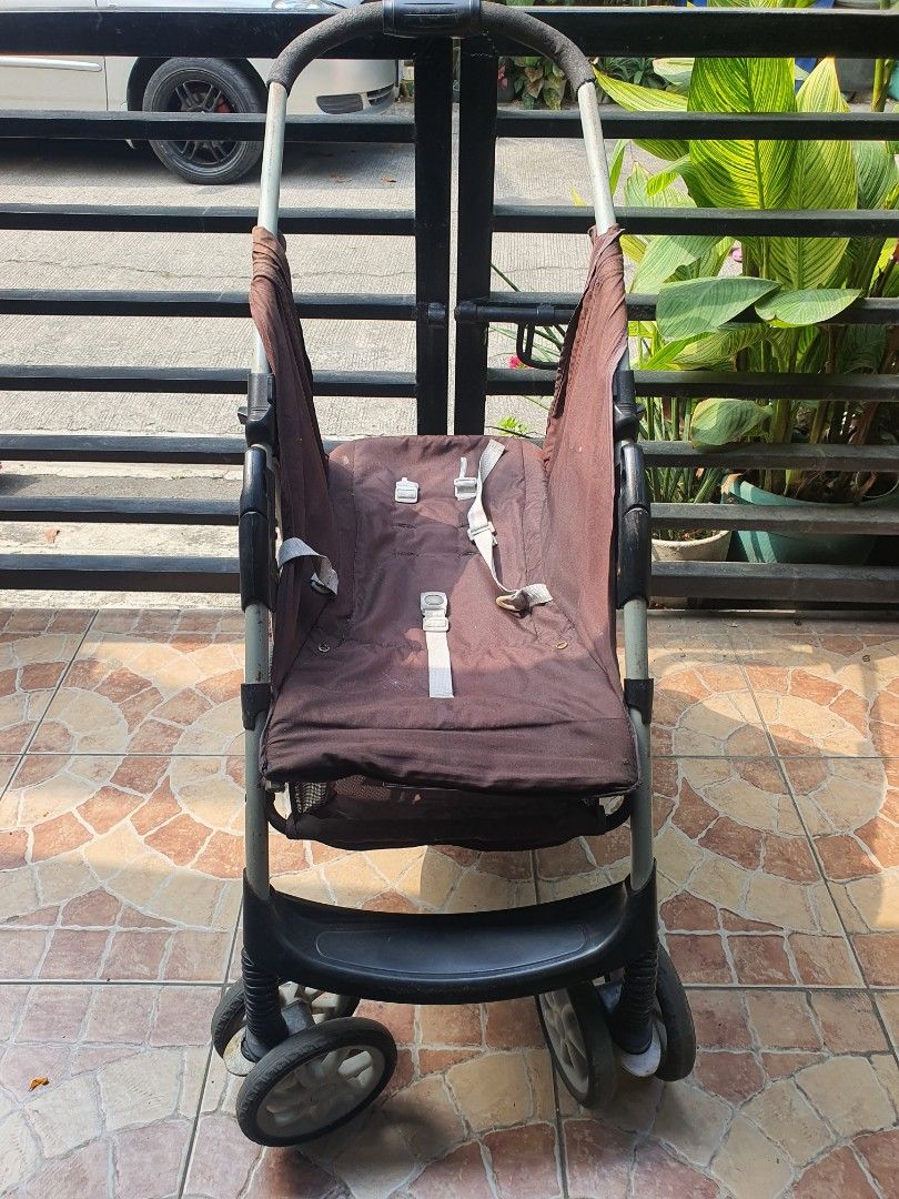 Brown Baby Stroller with Multi-Wheel Base (Category: Strollers) located in Paranaque City. Submitted by nicessities (Listing ID 1470750203, Image 1). Description: - Color:dark Brown with grey straps and a sturdy black frame - Comfort: Handlebar covered in soft black foam for a comfortable grip - Mobility: Multiple wheels designed for smooth rolling - Storage: Folds down compactly for easy transport and storage - Condition: Fabric shows some gener
