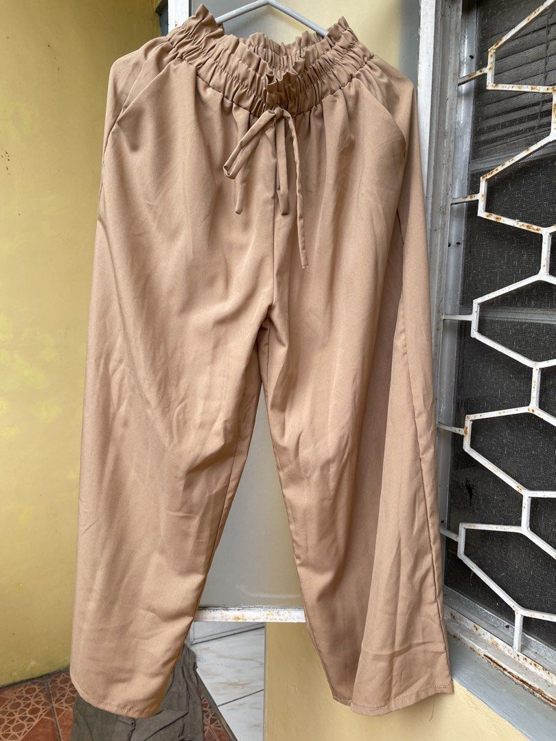 Brown high waist wide leg trousers with drawstring (Category: Trousers) located in Pasig City. Submitted by khaleisi (Listing ID 1470923613, Image 1). Description: - Color: Tan/brown - Fit: Loose wide-leg - Waist: High-waist with gathered ruffle paperbag detail - Closure/Detail: Matching fabric front drawstring tie - Pockets: Two functional side pockets - Material: Soft fabric with a nice, gentle drape - Style: Versatile and great for everyday ca
