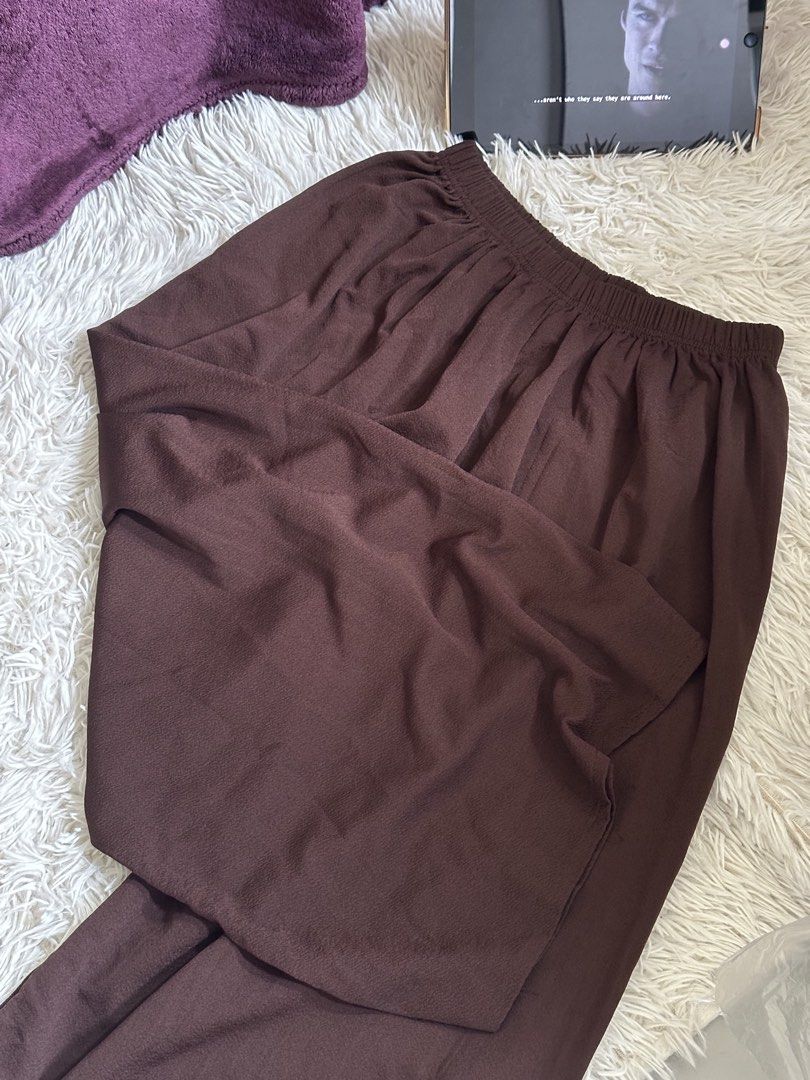 Brown high-waisted wide-leg pants (Category: Jeans) located in Taguig. Submitted by appatheseller (Listing ID 1470846920, Image 2). Description: Fits S-XXXL FREE SIZE - Color: Solid dark brown - Fit: Relaxed wide-leg with a comfortable stretchy elastic waistband - Fabric: Flowy material that drapes nicely - Style: Versatile everyday wear, easy to pair with casual tops or sweaters - Condition: Brand new / Excellent.