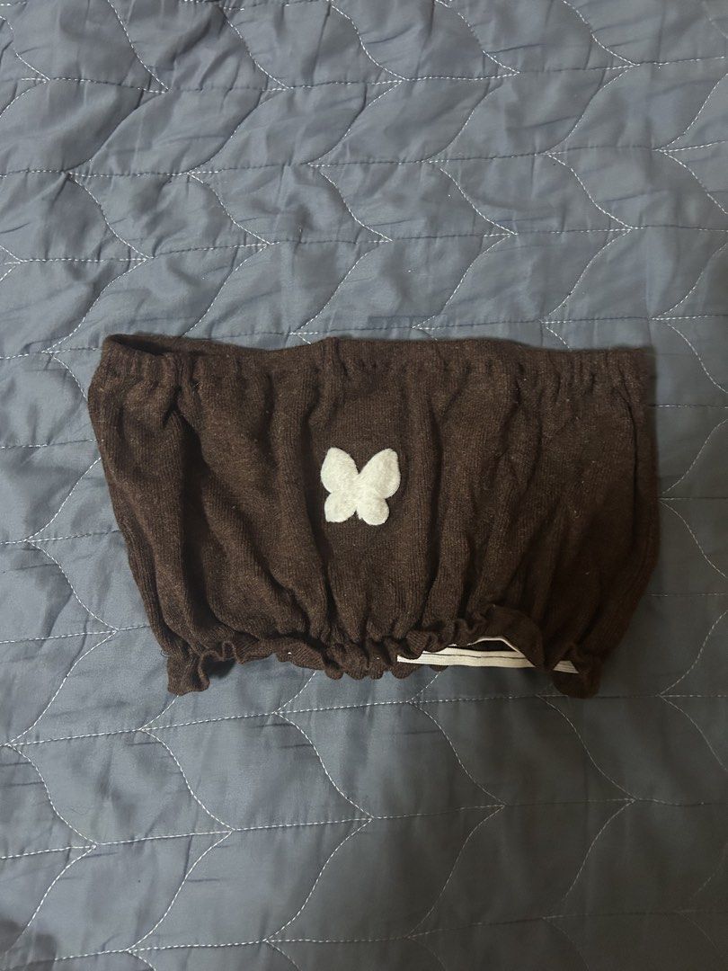 Brown knitted tube top with white butterfly patch (Category: Sleeveless) located in Manila. Submitted by ardol (Listing ID 1470766569, Image 1). Description: best fit to xs-small - Style: Strapless knit tube top in brown - Design: Cute white fuzzy butterfly patch in the center - Fit: Free size (fits most), with elasticated top and bottom edges for a snug hold - Material: Soft and comfortable fabric - Pairing: Looks great with high-waisted jeans o