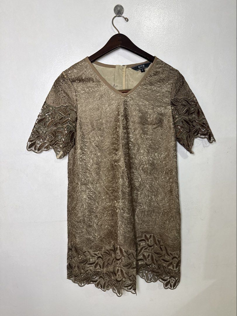 Brown Lace Dress (Category: Dresses) located in Quezon City. Submitted by dropdeadprices (Listing ID 1470849041, Image 1). Description: - Brand: EITIE - Size: 40 - Color: Gold - Material/Pattern: Beautiful textured lace overlay throughout - Design: Short sleeves, V-neckline with inner lining, and scalloped hem - Closure: Back neck zipper - 35- 39 inches length 19 inches pit to pit when laid flat.