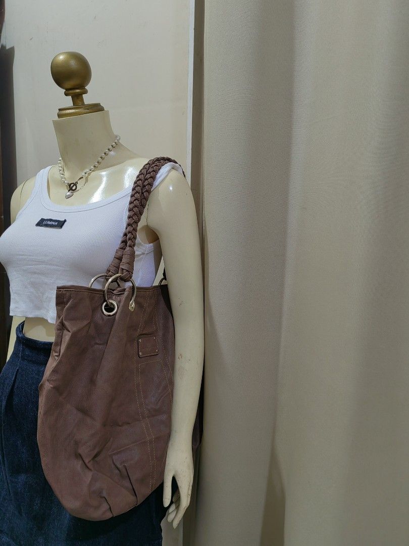 Brown Leather Shoulder Bag with Braided Straps (Category: Shoulder Bags) located in Makati City. Submitted by prelovedtreatedwithlove (Listing ID 1470872080, Image 1). Description: - Material: Premium textured brown leather - Storage: Roomy main compartment with secure closure and exterior back zip pocket - Details: 3 compartments with pockets. Large size No issue.