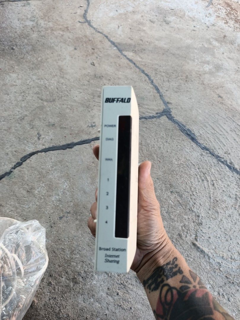 Buffalo Broad Station BBR-MG Broadband Router (Category: Networking) located in Taguig. Submitted by grandfish_55ab5c (Listing ID 1470895414, Image 1). Description: - Model: Buffalo Broad Station BBR-MG broadband router - Color: White casing - Ports: 1 WAN port and 4 LAN ports - Indicators: Front panel lights for power, diagnostic, WAN, and LAN 1-4 - Design: Compact desktop unit for easy internet sharing - Condition: Used with some surface marks 