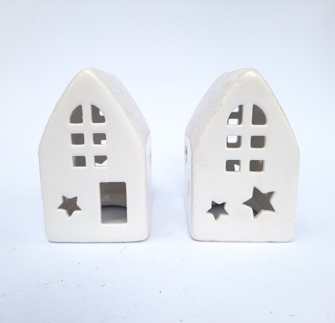 Bundle of Two White Ceramic House Tea Light Holders (Category: Other Home Decor) located in Marilao. Submitted by mariealeiah (Listing ID 1470754685, Image 1). Description: - Set of 2 white ceramic house candle holders - Features cute cutout windows and star shapes - Stylish textured roof finish - Ideal for tealights or small LED candles - Minimalist Scandinavian style that complements any neutral home decor - Perfect for your Christmas village.