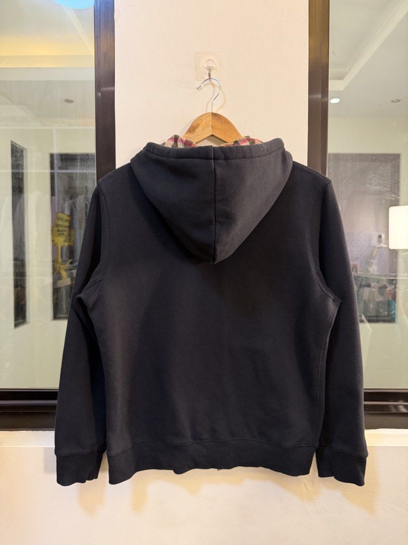 Burberry Full-Zip Hooded Sweatshirt (Category: Coats, Jackets and Outerwear) located in Paranaque City. Submitted by preluxeshop_ph (Listing ID 1470818171, Image 3). Description: Brand: Burberry London •Style: Full-Zip Hooded Sweatshirt / Zip Hoodie •Color: Black with signature vintage check lining inside the hood •Design Features: Full front zip closure with gold-tone hardware, drawstring hood with check pattern interior, front split kangaroo po