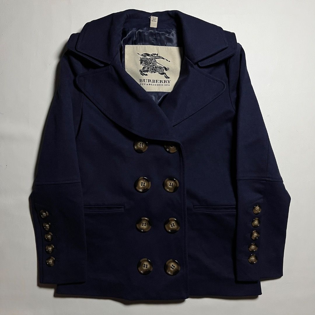 Burberry Navy Wool Double-breasted Coat (Category: Coats, Jackets and Outerwear) located in Caloocan City. Submitted by achilles_grails (Listing ID 1470844144, Image 1). Description: - Brand: Burberry - Style: Double-breasted pea coat - Color: Dark navy blue - Origin: Made in Italy - Features: Large lapels, decorative sleeve buttons, back half-belt, and blue patterned interior lining - Size: UK 8 / USA 6 / ITA 40 / GER 36 - Condition: Excellent, 