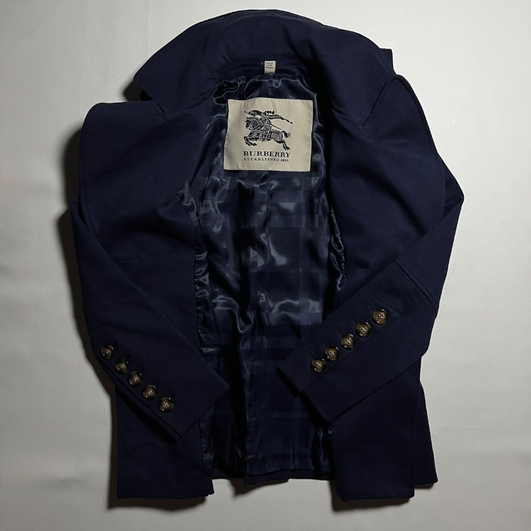 Burberry Navy Wool Double-breasted Coat (Category: Coats, Jackets and Outerwear) located in Caloocan City. Submitted by achilles_grails (Listing ID 1470844144, Image 2). Description: - Brand: Burberry - Style: Double-breasted pea coat - Color: Dark navy blue - Origin: Made in Italy - Features: Large lapels, decorative sleeve buttons, back half-belt, and blue patterned interior lining - Size: UK 8 / USA 6 / ITA 40 / GER 36 - Condition: Excellent, 