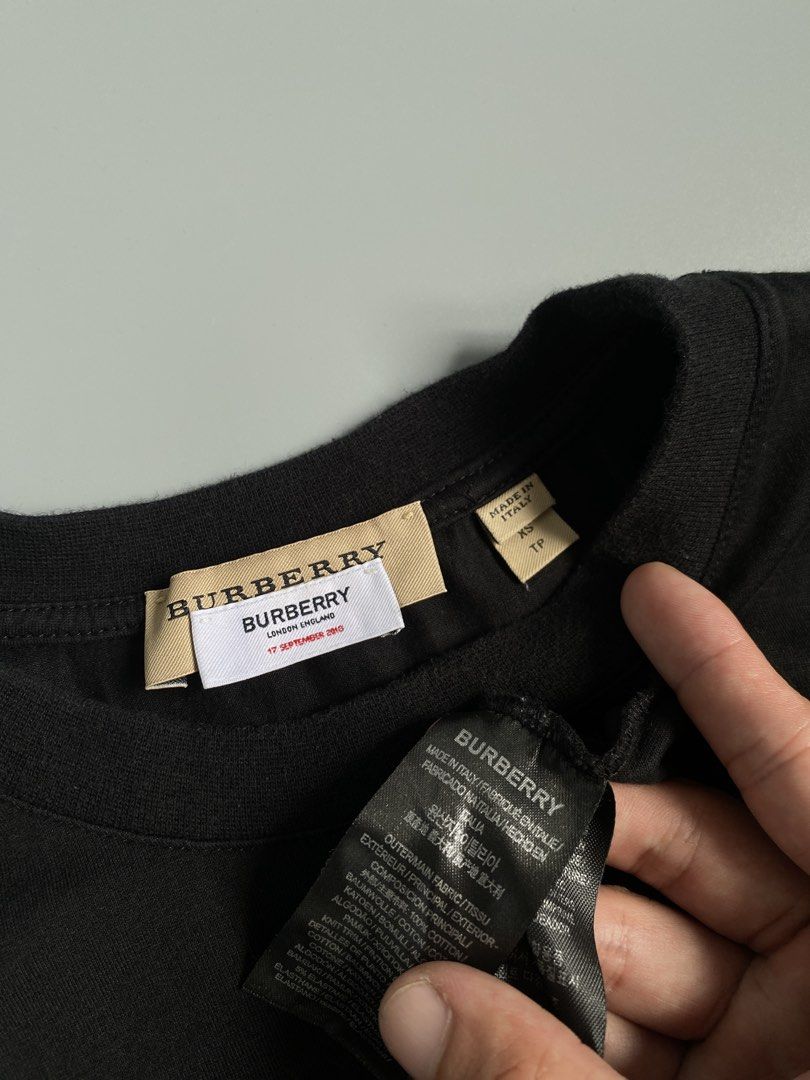 Burberry TB Monogram Logo Black T-Shirt (Category: Tshirts & Polo Shirts ) located in Cavite. Submitted by awuuu27 (Listing ID 1470748334, Image 2). Description: - Authentic Burberry t-shirt in timeless black - Size: XS (Made in Italy) - Material: Premium cotton - Design: White Thomas Burberry monogram print on chest, crew neck, short sleeves - Condition: Clean overall, inner tag still attached - Flaw note: Minor thread pull near the collar (refe