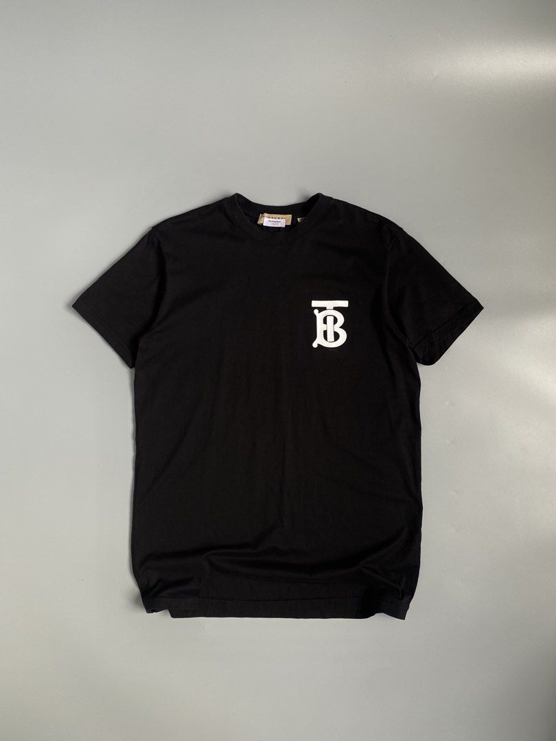 Burberry TB Monogram Logo Black T-Shirt (Category: Tshirts & Polo Shirts ) located in Cavite. Submitted by awuuu27 (Listing ID 1470748334, Image 1). Description: - Authentic Burberry t-shirt in timeless black - Size: XS (Made in Italy) - Material: Premium cotton - Design: White Thomas Burberry monogram print on chest, crew neck, short sleeves - Condition: Clean overall, inner tag still attached - Flaw note: Minor thread pull near the collar (refe