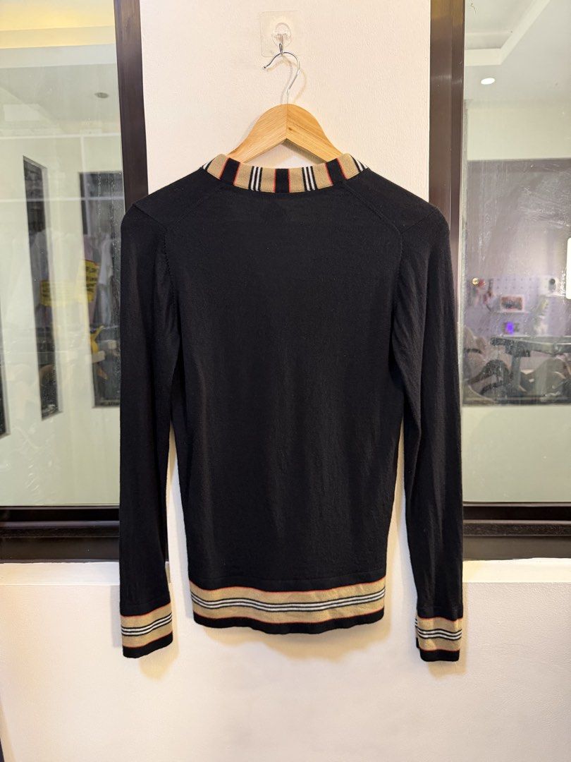 Burberry V-Neck Button-Up Cardigan Sweater (Category: Coats, Jackets and Outerwear) located in Paranaque City. Submitted by preluxeshop_ph (Listing ID 1470808707, Image 3). Description: Brand: Burberry London England -Style: V-Neck Button-Up Cardigan Sweater -Color: Black with Icon Stripe trim along the placket, collar, cuffs, and hem -Design Features: Front button closure, dual front patch pockets, V-neckline, and contrast signature striped ribb