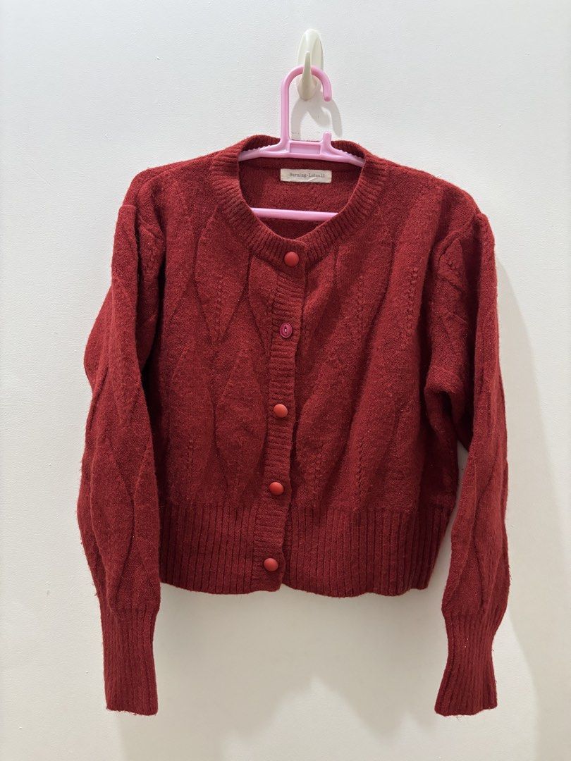 Burning Lotus Red Cable Knit Cardigan (Category: Coats, Jackets and Outerwear) located in Bacoor. Submitted by tummybeautyph (Listing ID 1470747091, Image 1). Description: - Brand: Burning Lotus - Color: Red - Material: Soft woolen texture - Design: Textured diamond pattern on front and back - Details: Round neckline, long sleeves, ribbed cuffs and hem, front button closure, with non transferrable glitters perfect for your Christmas parties - Con