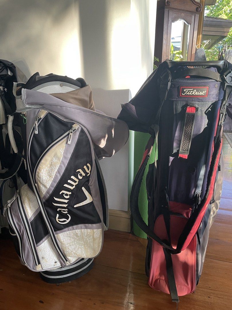 Callaway and Titleist Golf Bags (Category: Golf) located in Manila. Submitted by carmelabj (Listing ID 1470746554, Image 1). Description: - Callaway Golf Bag: Stylish black, grey, and white design with large branding - Titleist Golf Bag: Classic navy blue and red colorway with prominent Titleist text - Storage: Multiple zippered pockets on both bags for clubs, balls, and accessories - Portability: Equipped with sturdy handles and comfortable stra