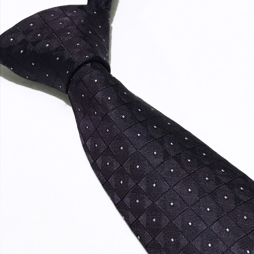 Calvin Klein NWT Deep Lavender Neck Tie (Category: Ties) located in Taguig. Submitted by retrogaze (Listing ID 1470800544, Image 1). Description: This 100% silk necktie by Calvin Klein features a deep lavender-eggplant base woven with an intricate, dimensional jacquard grid of micro-squares. Each square tile incorporates alternating diagonal directionality, creating a subtle geometric sheen punctuated by centered silver-white pin-dots. Recommende