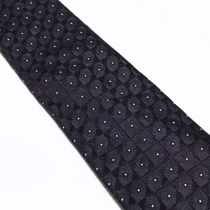Calvin Klein NWT Deep Lavender Neck Tie (Category: Ties) located in Taguig. Submitted by retrogaze (Listing ID 1470800544, Image 3). Description: This 100% silk necktie by Calvin Klein features a deep lavender-eggplant base woven with an intricate, dimensional jacquard grid of micro-squares. Each square tile incorporates alternating diagonal directionality, creating a subtle geometric sheen punctuated by centered silver-white pin-dots. Recommende