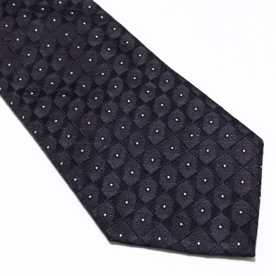 Calvin Klein NWT Deep Lavender Neck Tie (Category: Ties) located in Taguig. Submitted by retrogaze (Listing ID 1470800544, Image 2). Description: This 100% silk necktie by Calvin Klein features a deep lavender-eggplant base woven with an intricate, dimensional jacquard grid of micro-squares. Each square tile incorporates alternating diagonal directionality, creating a subtle geometric sheen punctuated by centered silver-white pin-dots. Recommende
