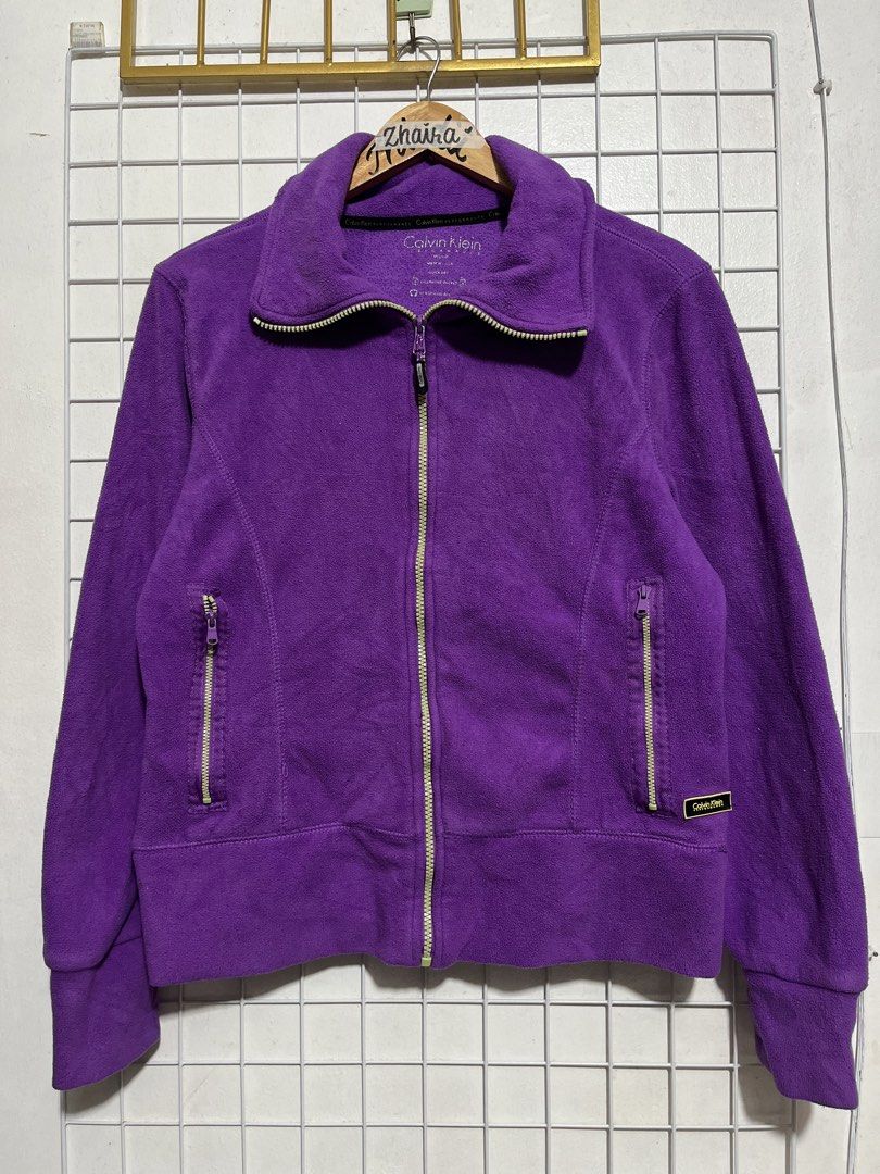 Calvin Klein Performance Purple Fleece Jacket Size Medium (Category: Coats, Jackets and Outerwear) located in Pagsanjan. Submitted by zhairaaaaa (Listing ID 1470786371, Image 2). Description: - Brand: Calvin Klein Performance - Size: Medium - Color: Vibrant Purple - Material: 100% soft polyester (quick-dry fabric) - Features: Zip-up front, zipped side pockets, dedicated cell phone pocket, and headphone access port - Ideal for: Chilly outdoor walk