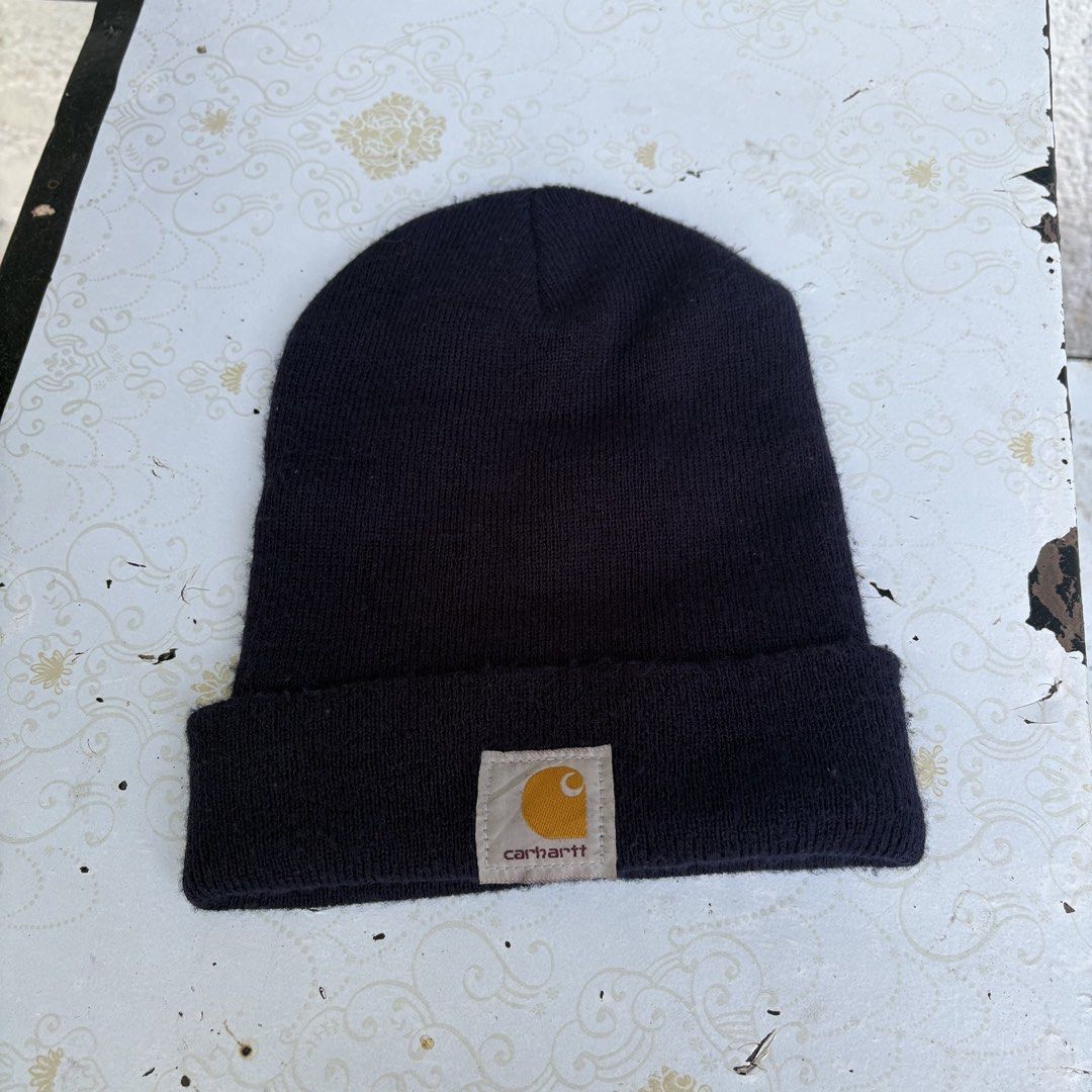 Carharrt Knit Beanie Hat Dark Navy Blue (Category: Caps & Hats) located in Quezon City. Submitted by vs.thrift444 (Listing ID 1470760326, Image 1). Description: - Authentic Carhartt knit beanie in dark navy blue - Features a classic ribbed texture and folded cuff - Iconic Carhartt square logo patch on the front - Soft, warm material ideal for cold weather - Standard adult size (fits most) - Condition note: Internal tag is cut off near the seam -f