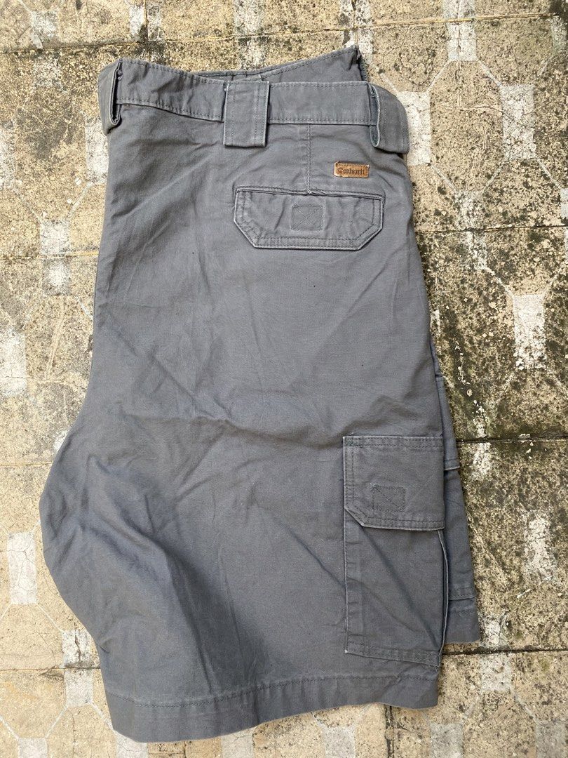 Carhartt Cargo Shorts Grey Size 40 (Category: Shorts) located in Imus. Submitted by frootiloots4103 (Listing ID 1470768344, Image 2). Description: - Brand: Carhartt - Color: Grey - Material: Sturdy canvas cotton - Size: 40 waist - Closure: Button fly - Pockets: Multiple side utility pockets and rear pockets - Details: Features iconic Carhartt logo patch on rear pocket - Condition/Use: Great for workwear or everyday casual use OPEN FOR NEGO (best 
