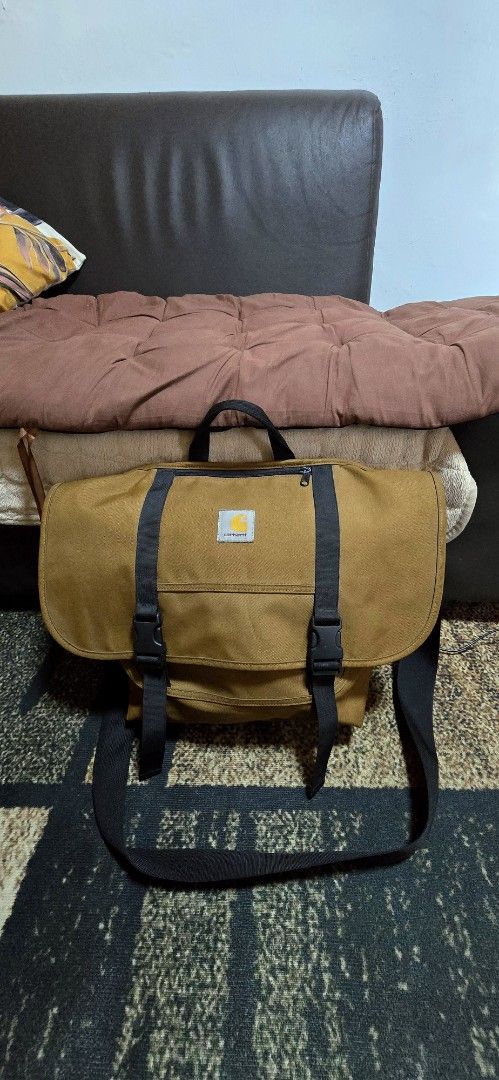 Carhartt Work In Progress Parcel Bag Brown Messenger Bag (Category: Sling Bags) located in Calamba. Submitted by elynkrenit24287 (Listing ID 1470808496, Image 1). Description: - Brand: Carhartt WIP May kaunting issue sa loob see pic nalang Excellent to as new - Color: Brown - Material: 100% durable and lightweight polyester - Closure: Large flap with dual buckle straps - Pockets: Front zip pocket for easy access - Carry Options: Top carry handle 