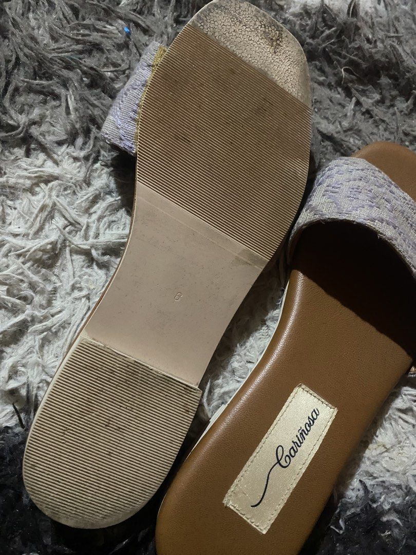 Cariñosa Purple Woven Pattern Slide Sandals Size 6 (Category: Flats & Sandals) located in Caloocan City. Submitted by remythrift (Listing ID 1470754989, Image 3). Description: - Brand: Cariñosa - Style: Slip-on sandals - Color: Tan and purple - Size: 6 (stamped on sole) - Upper: Textured woven pattern strap - Insole: Brown with stitched brand label - Sole: Low flat heel with textured rubber traction - Condition: Good, with slight wear at the toe 