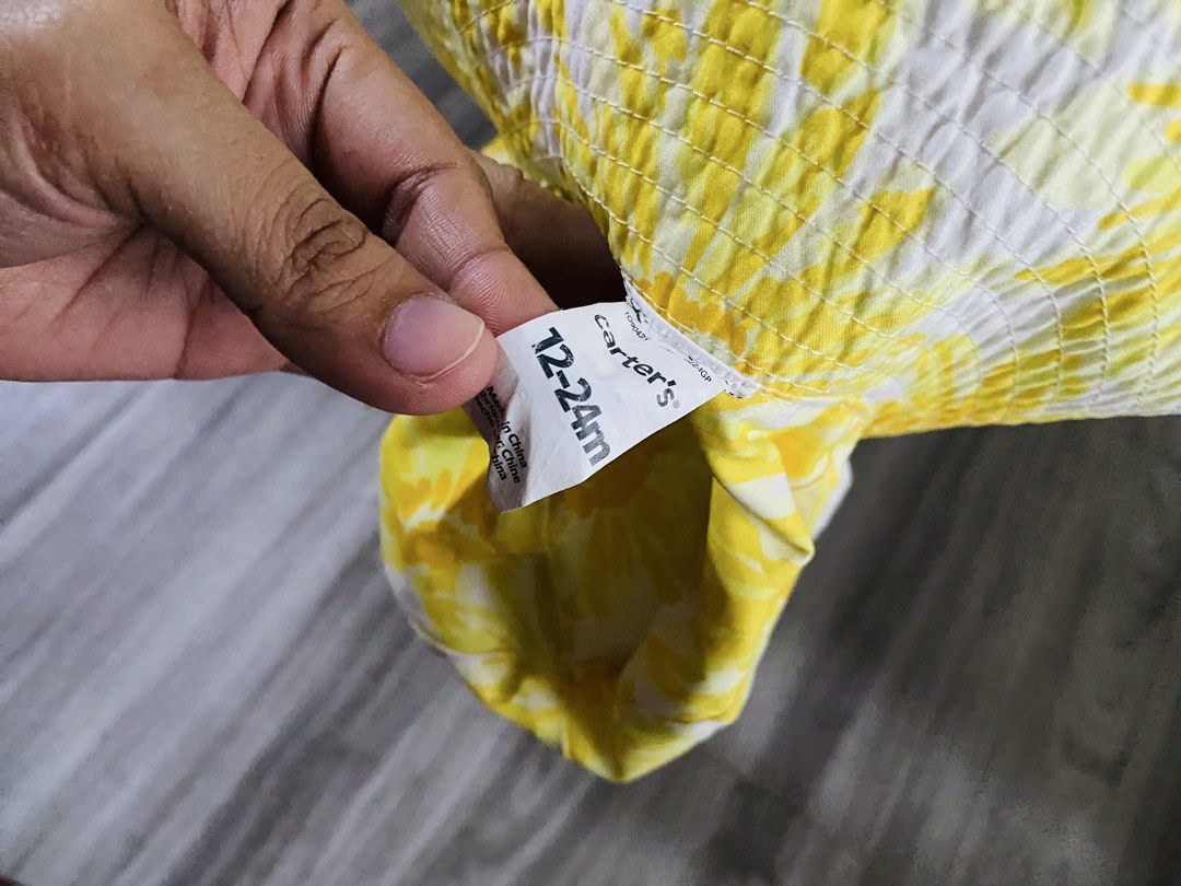 Carter's Yellow Floral Bucket Hat (Category: Babies & Kids Fashion) located in Caloocan City. Submitted by lovemyclothes21 (Listing ID 1470757809, Image 3). Description: - Brand: Carter's - Size: 12-24 months - Design: Bright yellow daisy print with solid white lining - Material: Lightweight cotton to keep baby cool - Features: Great sun protection for the park or beach - Condition: Excellent.