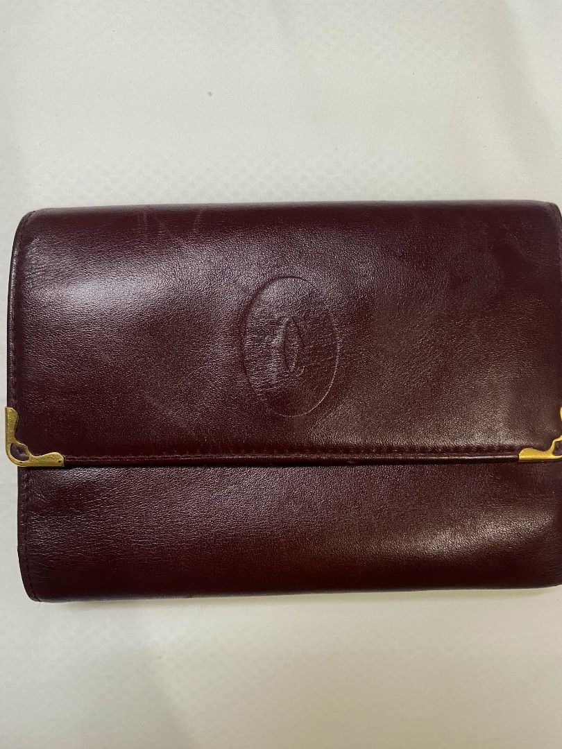Cartier Bordeaux Leather Long Wallet (Category: Luxury Bags & Wallets) located in Naga. Submitted by mrwisethrifter (Listing ID 1470846799, Image 1). Description: - Brand: Cartier - Material: Premium bordeaux leather with gold-tone hardware - Design: Embossed Cartier double C logo on front flap - Interior: Multiple card slots, bill compartments, and a kiss-lock coin pocket - Authenticity: Cartier Paris gold stamping on the interior leather flap -