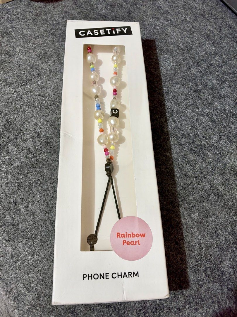 Casetify Rainbow Pearl Phone Charm (Category: Cases & Sleeves) located in Taytay. Submitted by techie01 (Listing ID 1470829543, Image 1). Description: - Brand: Casetify - Design: Rainbow Pearl with colorful seed beads and faux pearls - Feature: Includes a unique black letter bead - Inclusion: Comes with original retail box - Compatibility: Universal loop attachment for all phone cases.