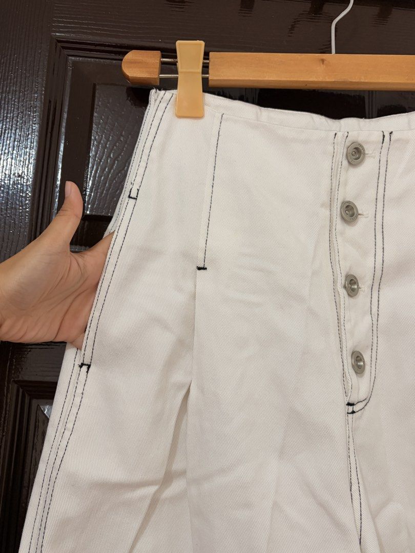 Cekeke White Wide Leg Pants Size M (Category: Jeans) located in Marikina City. Submitted by _bananahanaa (Listing ID 1470804297, Image 3). Description: - Brand: Cekeke - Size: M (160/64A measurements) fits 27 waist - Color: Clean white with stylish contrast black stitching - Fit: High-waisted, wide-leg style - Details: Pleated waist, front button placket, 2 functional side pockets, and faux back pockets - Material: Cotton-like denim.