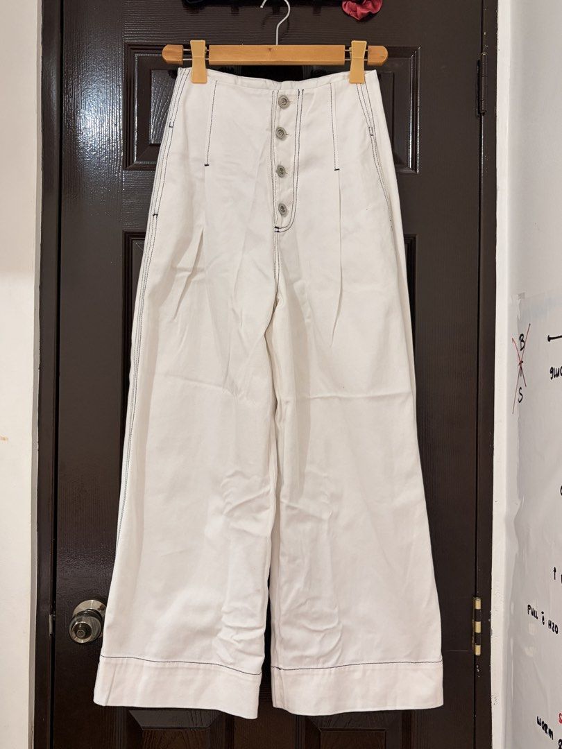 Cekeke White Wide Leg Pants Size M (Category: Jeans) located in Marikina City. Submitted by _bananahanaa (Listing ID 1470804297, Image 1). Description: - Brand: Cekeke - Size: M (160/64A measurements) fits 27 waist - Color: Clean white with stylish contrast black stitching - Fit: High-waisted, wide-leg style - Details: Pleated waist, front button placket, 2 functional side pockets, and faux back pockets - Material: Cotton-like denim.
