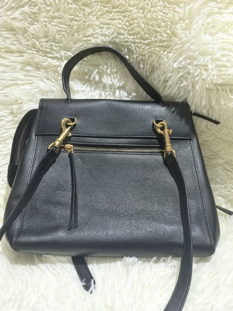 Celine Black Leather Handbag with Strap (Category: Luxury Bags & Wallets) located in Tacloban City. Submitted by thead.declutters (Listing ID 1470880079, Image 3). Description: - Material: Premium black textured leather with luxury gold-tone hardware - Versatility: Includes a sturdy top handle and a removable shoulder strap with clasp closure - Closure & Security: Flap top with a secure magnetic snap button - Pockets: Convenient exterior back zip