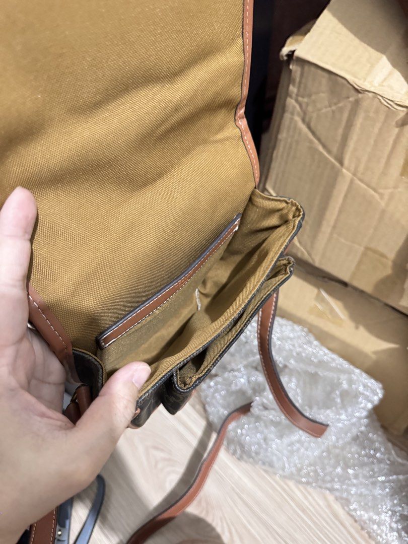 Celine Triomphe Canvas Saddle Crossbody Bag Brown (Category: Luxury Bags & Wallets) located in Manila. Submitted by dearpinkcollections (Listing ID 1470849506, Image 3). Description: - Authentic Celine crossbody bag in classic Triomphe monogram canvas - Tan leather trim with stylish white contrast stitching - Elegant gold-tone hardware and secure flap closure with buckle detail - Celine Paris logo stamped clearly on the front tab - Adjustable sho