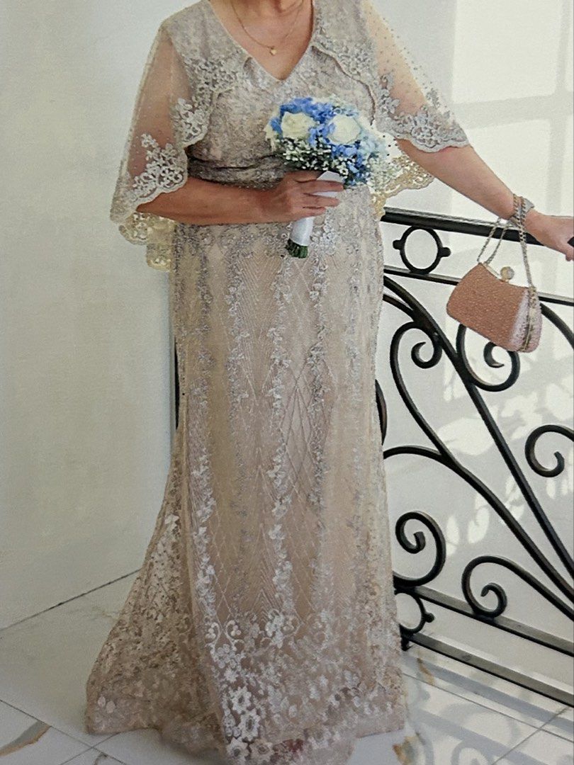 Champagne Beaded Lace Formal Evening Gown (Category: Evening dresses & gowns) located in Santa Rosa. Submitted by chu1019 (Listing ID 1470817534, Image 2). Description: - Color: Elegant champagne with intricate silver lace embroidery, sequins, and beadwork - Design: V-neckline with an attached sheer capelet over the shoulders and arms - Fit: Fitted silhouette with a beaded waistline and a slight flare at the floor-length hem - Condition: Excellen