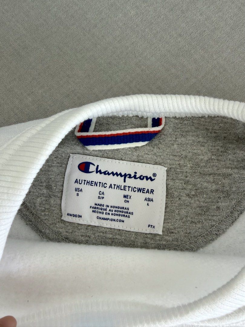 Champion Authentic Athleticwear White Sweatshirt (Category: Coats, Jackets and Outerwear) located in Lipa City. Submitted by pauline0303 (Listing ID 1470806322, Image 3). Description: - Authentic white Champion crewneck sweatshirt - Size: Small (USA) / Large (Asia) - Classic embroidered logo on the chest - Signature small patch on the left sleeve - Ribbed collar, cuffs, and hem for a snug fit - Clean white fabric, great for everyday layering.