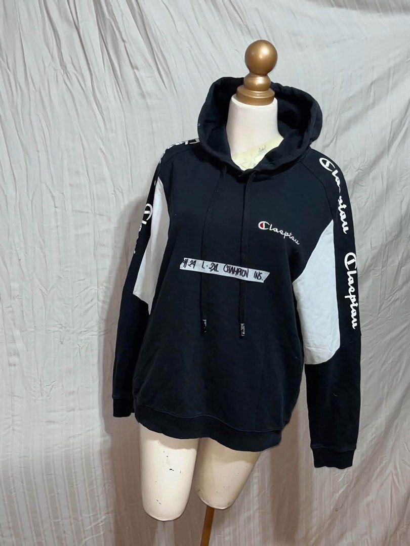 Champion Black White Colorblock Hoodie With Script Logo (Category: Hoodies) located in General Trias. Submitted by crissy9053136 (Listing ID 1470760991, Image 1). Description: - Brand: Champion - Color: Black with white sleeve panels - Logo: Classic embroidered script logo on chest - Details: Branded tape along both sleeves, drawstring hood, front kangaroo pocket - Fit: Ribbed cuffs and hem to maintain shape - Condition: Excellent / Ready to wear