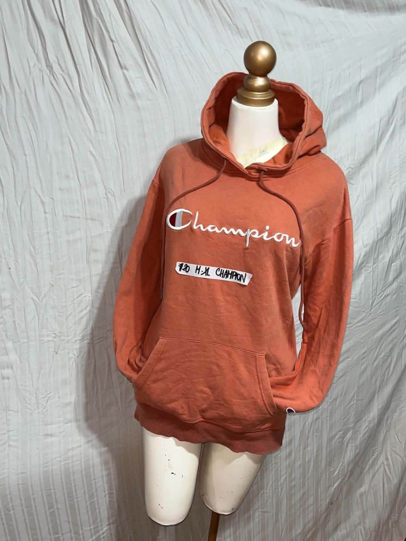 Champion Orange Pullover Hoodie Sweatshirt (Category: Coats, Jackets and Outerwear) located in General Trias. Submitted by crissy9053136 (Listing ID 1470760922, Image 1). Description: - Brand: Champion - Color: Bright Orange with large white embroidered chest logo - Style: Classic streetwear pullover hoodie - Features: Drawstring hood, front kangaroo pocket, ribbed cuffs and hem - Comfort: Soft, warm material on the inside - Condition: Excellent 