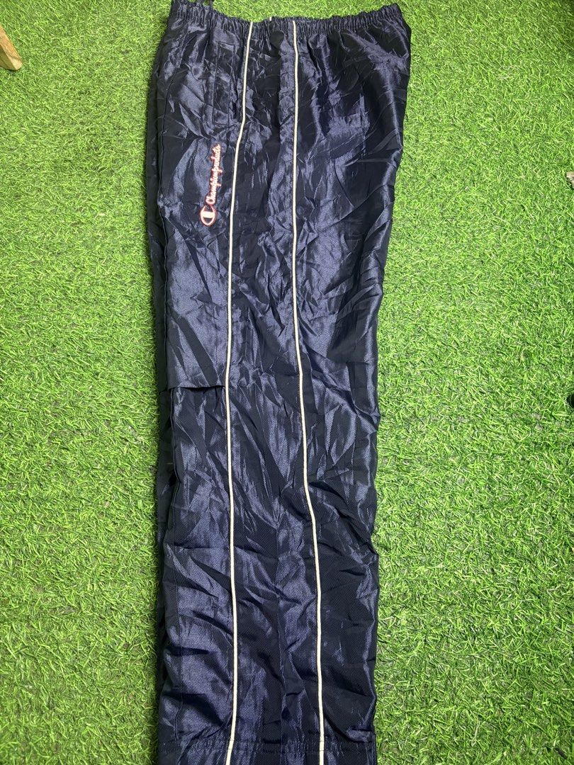 Champion track pant (Category: Trousers) located in Manila. Submitted by josh2295 (Listing ID 1470762624, Image 3). Description: vintage navy blue Champion nylon track pants with white piping and embroidered “Champion products” script down the side. W:34-36 L: 38 LH:7.5.