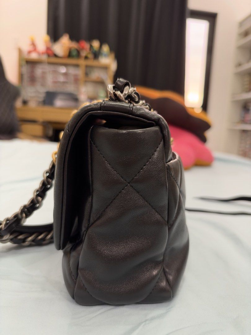Chanel 19 Flap Bag Black (Category: Luxury Bags & Wallets) located in Bulacan. Submitted by rich3lle (Listing ID 1470831748, Image 3). Description: - Brand: Chanel - Material: Black quilted soft leather - Hardware: Chunky gold-tone CC turn-lock and mixed gold/ruthenium chain strap - Exterior: Classic quilted pattern on body and sides, convenient back slip pocket - Structure: Structured shape with soft leather construction - Condition: Excellent (