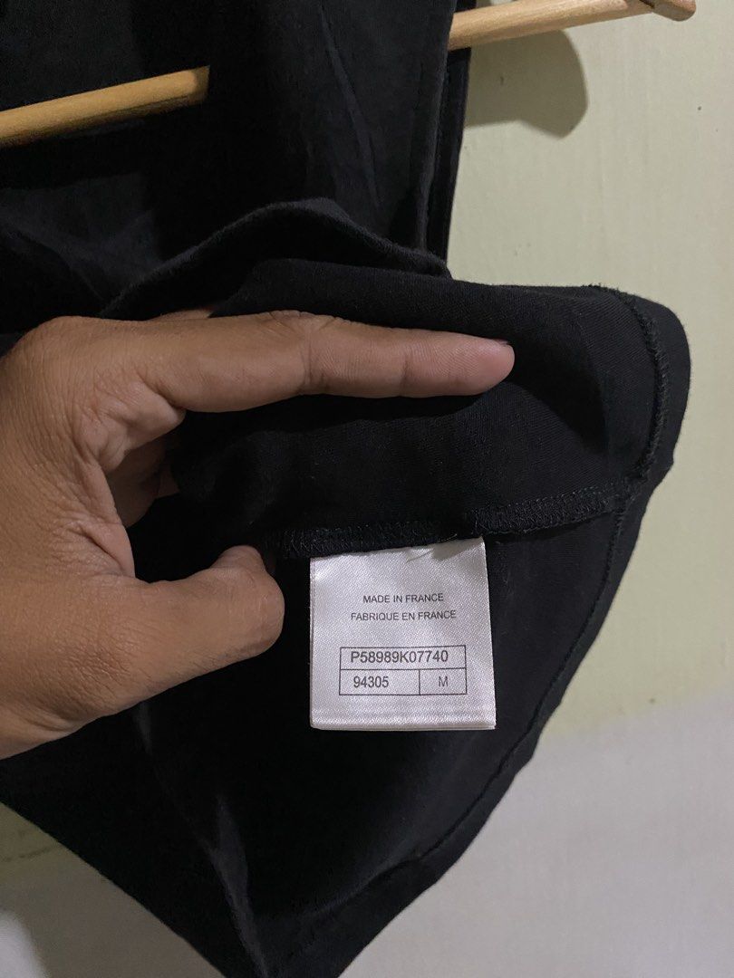 Chanel Black Cotton Tank Top Size M (Category: Sleeveless) located in Pandi. Submitted by nasya_thrift_collection2023 (Listing ID 1470858014, Image 3). Description: - Brand: Chanel - Color: Classic Black - Size: Medium (Fits true to size) - Material: 100% Premium Cotton - Origin: Made in France - Design: Sleeveless with round neckline and iconic white embroidered Chanel lettering along the bottom hem - Condition: Excellent, with care tags still a