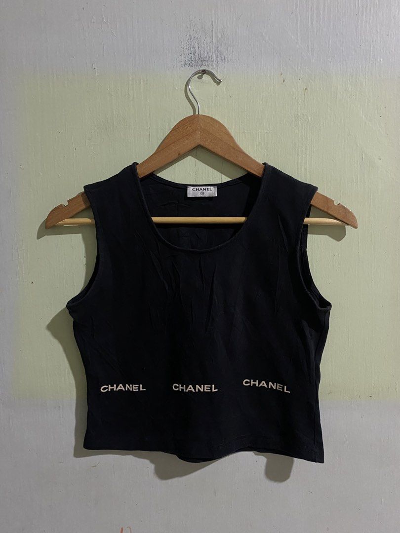 Chanel Black Cotton Tank Top Size M (Category: Sleeveless) located in Pandi. Submitted by nasya_thrift_collection2023 (Listing ID 1470858014, Image 1). Description: - Brand: Chanel - Color: Classic Black - Size: Medium (Fits true to size) - Material: 100% Premium Cotton - Origin: Made in France - Design: Sleeveless with round neckline and iconic white embroidered Chanel lettering along the bottom hem - Condition: Excellent, with care tags still a