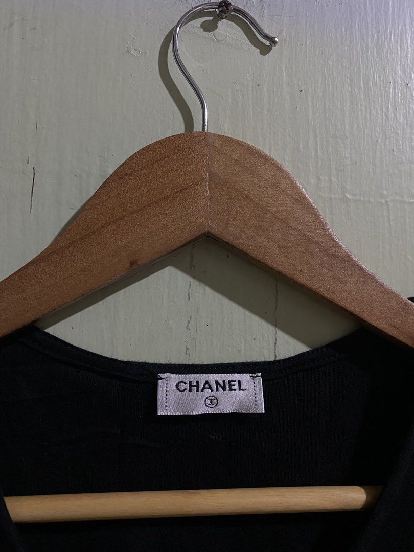 Chanel Black Cotton Tank Top Size M (Category: Sleeveless) located in Pandi. Submitted by nasya_thrift_collection2023 (Listing ID 1470858014, Image 2). Description: - Brand: Chanel - Color: Classic Black - Size: Medium (Fits true to size) - Material: 100% Premium Cotton - Origin: Made in France - Design: Sleeveless with round neckline and iconic white embroidered Chanel lettering along the bottom hem - Condition: Excellent, with care tags still a