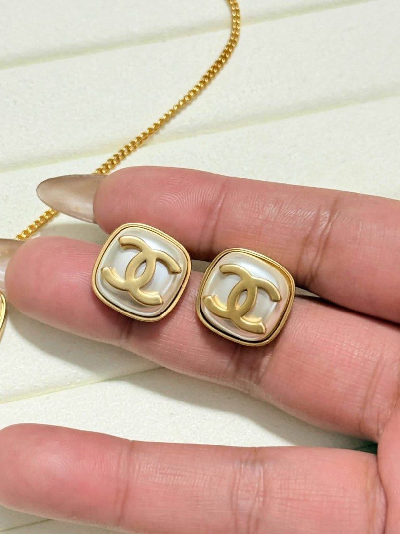 Chanel CC Pearl Necklace and Earring Set (Category: Necklaces) located in Lopez. Submitted by thrift.ni.roms22 (Listing ID 1470743846, Image 3). Description: - Chanel jewelry set (Square pearl necklace & clip-on earrings) - Elegant gold hardware with white faux pearl centers and iconic CC logos - Necklace features a secure lobster clasp and cute CC charm dangle at the extender - Crafted in Italy with high-end detailing - Message us for more detai