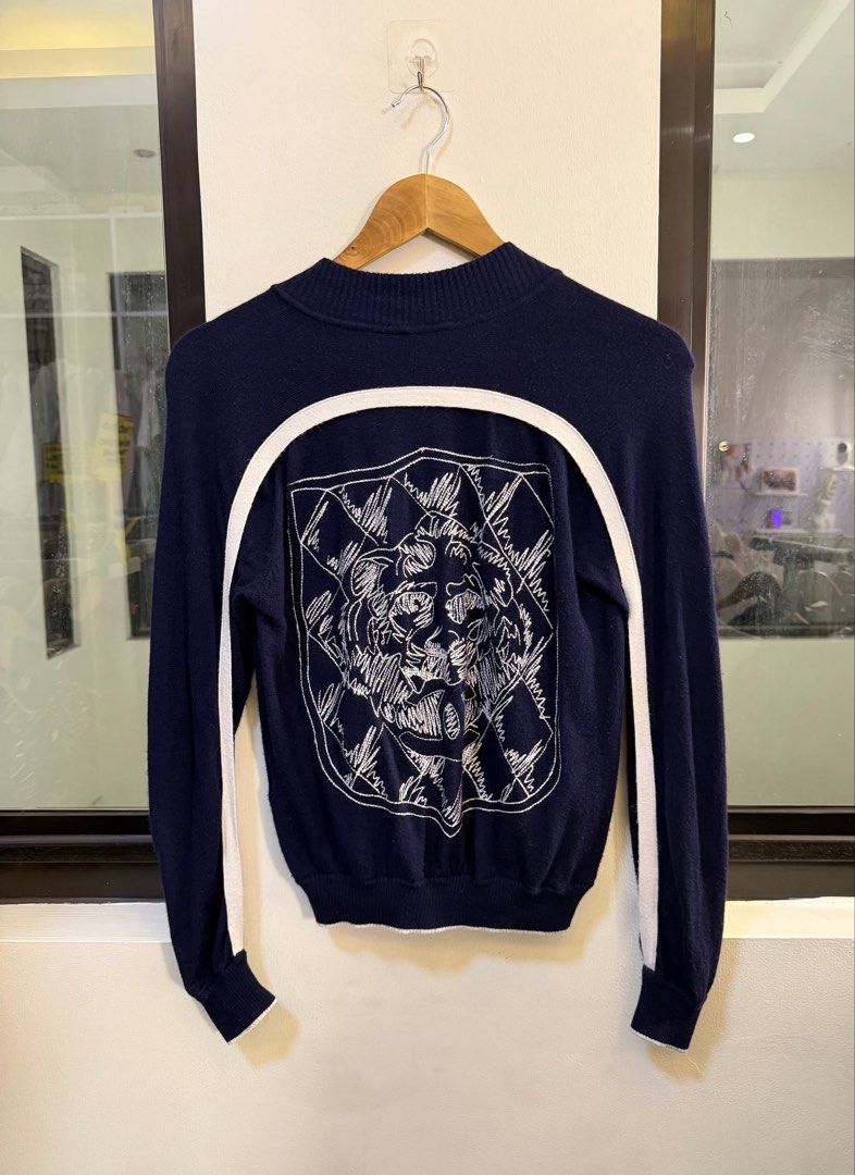 CHANEL Full-Zip Knit Cardigan Jacket (Category: Coats, Jackets and Outerwear) located in Paranaque City. Submitted by preluxeshop_ph (Listing ID 1470811602, Image 3). Description: Brand: CHANEL -Style: Full-Zip Knit Cardigan Jacket / Zip-Up Sweater -Color: Navy Blue with white trim piping along the hem and shoulders -Design Features: Large embroidered line-art tiger graphic across the back, full front zipper closure, white contrast accent trim fr