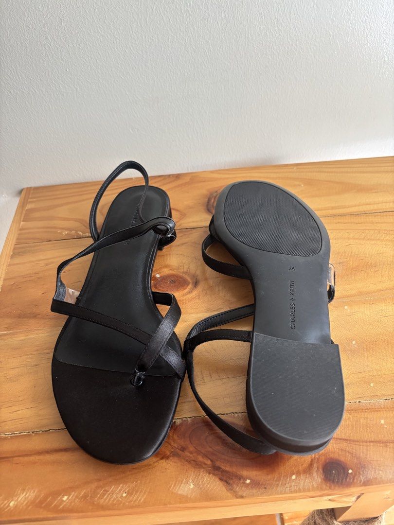 Charles & Keith Arden Satin Wavy Toe-Ring Sandals (Category: Flats & Sandals) located in Mandaluyong City. Submitted by kthln (Listing ID 1470772376, Image 2). Description: - Brand/Model: Charles & Keith Arden Satin Wavy Toe-Ring Sandals - Size: 38 (marked on sole) - With box Bought from Changi Airport RFS: I realized the size is too big after using it once. .