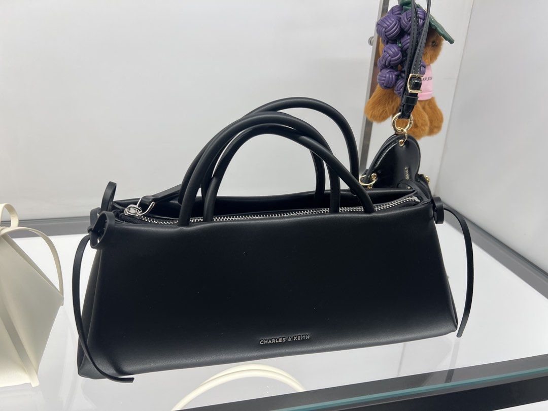 Charles & Keith Black Handbag CK2-20160193 (Category: Luxury Bags & Wallets) located in Lipa City. Submitted by thyra06 (Listing ID 1470852158, Image 1). Description: - Brand: Charles & Keith - Style: Structured Handbag with Top Handle (Style Code: CK2-20160193) - Size: Medium - Colour: Noir (Matte Black finish) - Features: Secure zip closure and elegant side ribbon detail - Condition: Brand new with original store price tag still attached to the